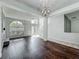 Bright and airy living room with hardwood floors, staircase, and large arched windows for ample natural light at 9454 Candice Ct, Orlando, FL 32832