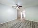 Living room featuring wood-look floors and neutral walls with a ceiling fan at 9454 Candice Ct, Orlando, FL 32832