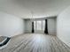 A spacious living room with hardwood floors, a chandelier, and lots of natural light at 9454 Candice Ct, Orlando, FL 32832