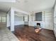 Bright living room featuring a fireplace, built-in shelving, hardwood floors, and modern chandelier at 9454 Candice Ct, Orlando, FL 32832