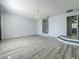 A spacious living room features hard wood flooring, steps, and a chandelier at 9454 Candice Ct, Orlando, FL 32832