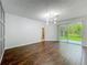 Bright living room with modern chandelier, wood floors, and sliding glass doors to outdoor patio at 9454 Candice Ct, Orlando, FL 32832