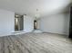 A spacious living room with hard wood flooring, steps, and a chandelier at 9454 Candice Ct, Orlando, FL 32832