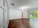Bright living room with modern chandelier, wood floors, accent wall and sliding glass doors to outdoor patio at 9454 Candice Ct, Orlando, FL 32832