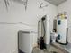 Close-up of water softener system and hot water tank, mounted on the wall at 9454 Candice Ct, Orlando, FL 32832