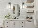 Bathroom featuring marble countertop vanity, modern lighting, and open shelving at 9809 Covent Garden Dr # Drive, Orlando, FL 32827