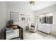 Cozy Bedroom with a crib, glider chair, and a collection of charming wall decor at 9809 Covent Garden Dr # Drive, Orlando, FL 32827