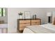 Bedroom with dresser, stylish decor, and a doorway leading to another room, enhancing the open layout at 9809 Covent Garden Dr # Drive, Orlando, FL 32827