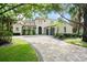 Stunning Mediterranean-style home featuring a clay tile roof and beautiful paver driveway at 9809 Covent Garden Dr # Drive, Orlando, FL 32827