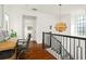 Bright hallway features hardwood floors, modern light fixture, and adjacent office space at 9809 Covent Garden Dr # Drive, Orlando, FL 32827
