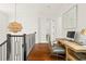 Hallway with staircase, modern chandelier, hardwood floors, and a desk with computer at 9809 Covent Garden Dr # Drive, Orlando, FL 32827