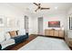 Upstairs living area with dark wood floors, comfortable blue couch, and modern ceiling fan at 9809 Covent Garden Dr # Drive, Orlando, FL 32827