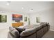 Spacious media room with large comfy couch, natural light and modern entertainment center at 9809 Covent Garden Dr # Drive, Orlando, FL 32827