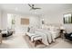 Bright bedroom with neutral colors, plush bedding, accent furniture, and a connecting bathroom at 9809 Covent Garden Dr # Drive, Orlando, FL 32827