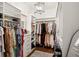 Spacious walk-in closet with custom shelving, drawers, and hanging racks for optimal organization at 9809 Covent Garden Dr # Drive, Orlando, FL 32827
