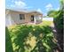 Backyard with a covered patio, green grass, and a white fence at 9982 Shadow Creek Dr, Orlando, FL 32832
