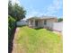 Backyard featuring a covered patio, green grass, and privacy fence at 9982 Shadow Creek Dr, Orlando, FL 32832