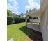 A well-maintained backyard with green grass and a covered patio area at 9982 Shadow Creek Dr, Orlando, FL 32832