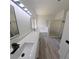 Bathroom featuring a double sink vanity, quartz countertop, and a separate tub and shower at 9982 Shadow Creek Dr, Orlando, FL 32832