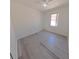 Bedroom featuring wood-look flooring, ceiling fan, and window with natural light at 9982 Shadow Creek Dr, Orlando, FL 32832