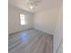 Bedroom featuring wood-look flooring, ceiling fan, and window with natural light at 9982 Shadow Creek Dr, Orlando, FL 32832
