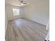 Bedroom featuring wood-look flooring, a ceiling fan, and natural light from the window at 9982 Shadow Creek Dr, Orlando, FL 32832
