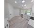 Contemporary kitchen with stainless steel appliances, white cabinets, and view into adjacent room at 9982 Shadow Creek Dr, Orlando, FL 32832