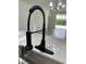 Close-up of the kitchen sink with a modern black faucet, showcasing quartz counters and updated features at 9982 Shadow Creek Dr, Orlando, FL 32832