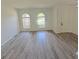 Open-concept living room featuring updated floors, arched windows, and neutral paint at 9982 Shadow Creek Dr, Orlando, FL 32832