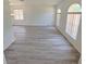 Bright living room boasts new floors, fresh paint, and plenty of natural light from arched windows at 9982 Shadow Creek Dr, Orlando, FL 32832