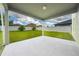 An outdoor patio with a view of the spacious, fenced backyard and clear blue skies above at 1951 Betsy Ross Ln, St Cloud, FL 34769