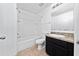 A clean bathroom featuring a shower-tub combo and a dark vanity with a granite countertop at 1951 Betsy Ross Ln, St Cloud, FL 34769