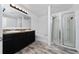 Bathroom featuring a double vanity, soaking tub, and separate glass-enclosed shower at 1951 Betsy Ross Ln, St Cloud, FL 34769
