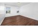 Bedroom with wood floors and natural light from the two windows overlooking a pond at 1951 Betsy Ross Ln, St Cloud, FL 34769