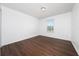 An empty bedroom with hardwood floors and natural light coming in from a window at 1951 Betsy Ross Ln, St Cloud, FL 34769