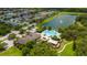 Aerial view of a community pool, lake with fountain, clubhouse, and green space at 1951 Betsy Ross Ln, St Cloud, FL 34769