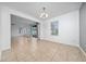 Open-concept dining room filled with natural light, showcasing neutral tile floors and modern lighting fixture at 1951 Betsy Ross Ln, St Cloud, FL 34769