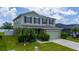 Charming two-story home featuring lush landscaping, an attached two car garage, and an inviting facade at 1951 Betsy Ross Ln, St Cloud, FL 34769