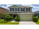 Charming two-story home featuring lush landscaping, an attached two car garage, and an inviting facade at 1951 Betsy Ross Ln, St Cloud, FL 34769