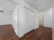 Hallway with wood floors, multiple closets, and access to other rooms in the home at 1951 Betsy Ross Ln, St Cloud, FL 34769