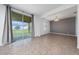 Bright living room with sliding glass doors leading to the backyard and neutral tile floors at 1951 Betsy Ross Ln, St Cloud, FL 34769