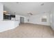 Spacious living area showcases an open-concept layout, tiled floors, and seamlessly connects to the kitchen at 1951 Betsy Ross Ln, St Cloud, FL 34769