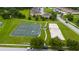 Aerial shot of community tennis and sand volleyball courts with surrounding green space and trees at 1951 Betsy Ross Ln, St Cloud, FL 34769