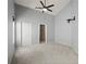 Bedroom with neutral carpet, large closet, access to the ensuite bathroom, and a ceiling fan at 10473 Glassborough Dr, Orlando, FL 32825