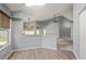 Dining area with bar top overlooking the kitchen and open to the living room, offering seamless interaction at 10473 Glassborough Dr, Orlando, FL 32825