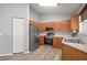 Well-equipped kitchen with stainless steel appliances, wood cabinets, and lots of natural light from the window at 10473 Glassborough Dr, Orlando, FL 32825