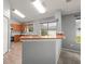 Kitchen with wooden cabinets, a breakfast bar, and stainless steel appliances, offering a functional layout at 10473 Glassborough Dr, Orlando, FL 32825