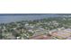 Scenic aerial view of a community near the water, showcasing the pool, mature trees, and convenient parking options at 1100 E Caroline St # 204, Tavares, FL 32778
