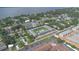 Breathtaking aerial shot of a community with a pool, surrounded by lush trees and a stunning waterfront view for residents at 1100 E Caroline St # 204, Tavares, FL 32778