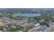 Panoramic aerial shot of a community featuring well-maintained buildings, a sparkling pool, and scenic lakeside surroundings at 1100 E Caroline St # 204, Tavares, FL 32778